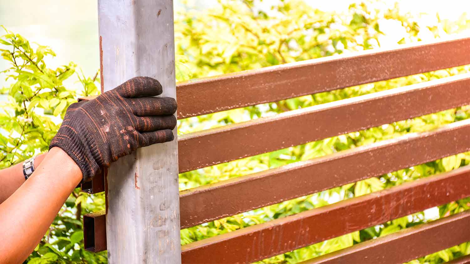person repairing house fence