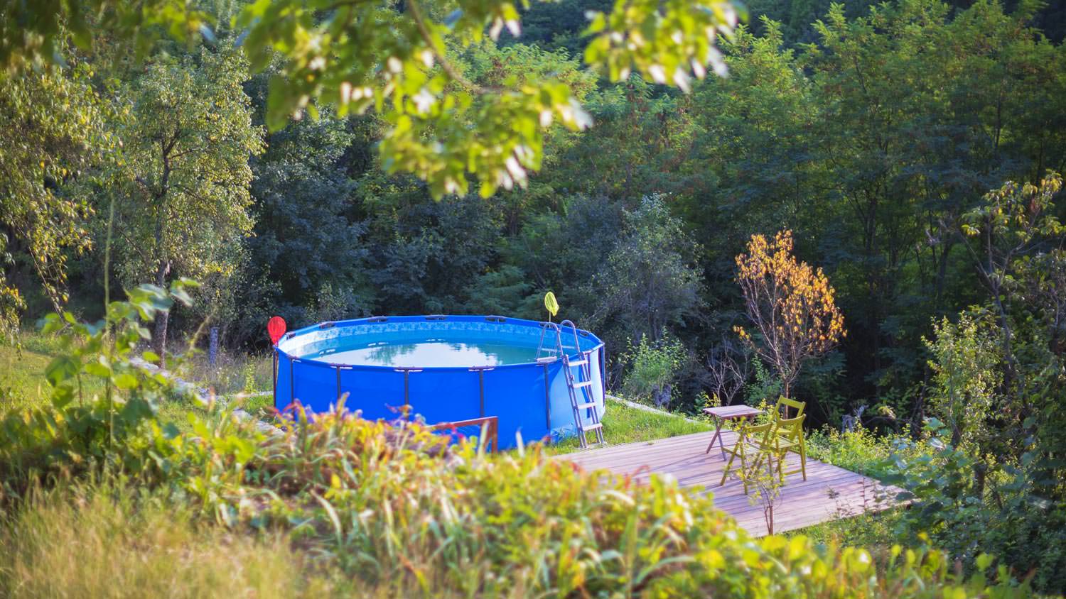An above ground pool in the backyard of a house