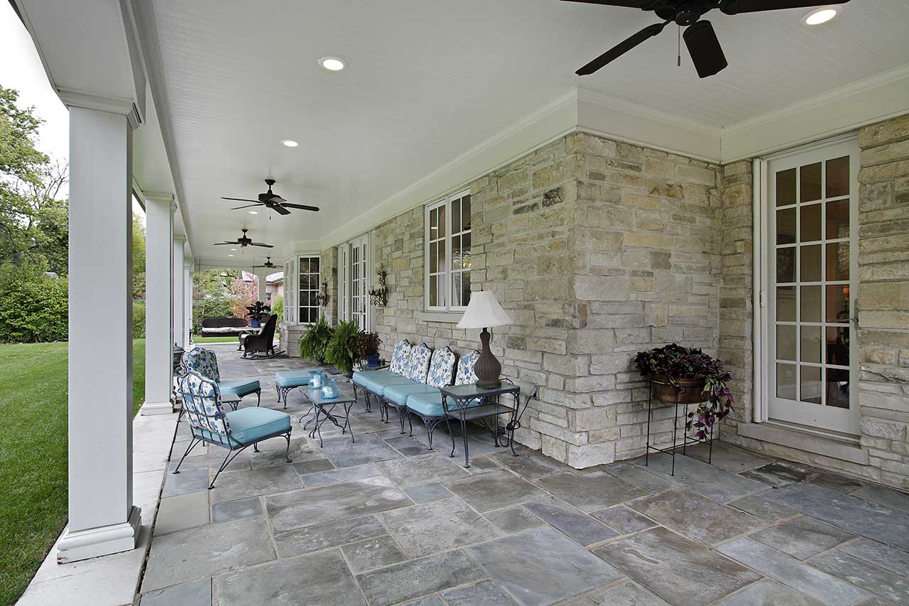 backyard bluestone patio with columns and patio furniture
