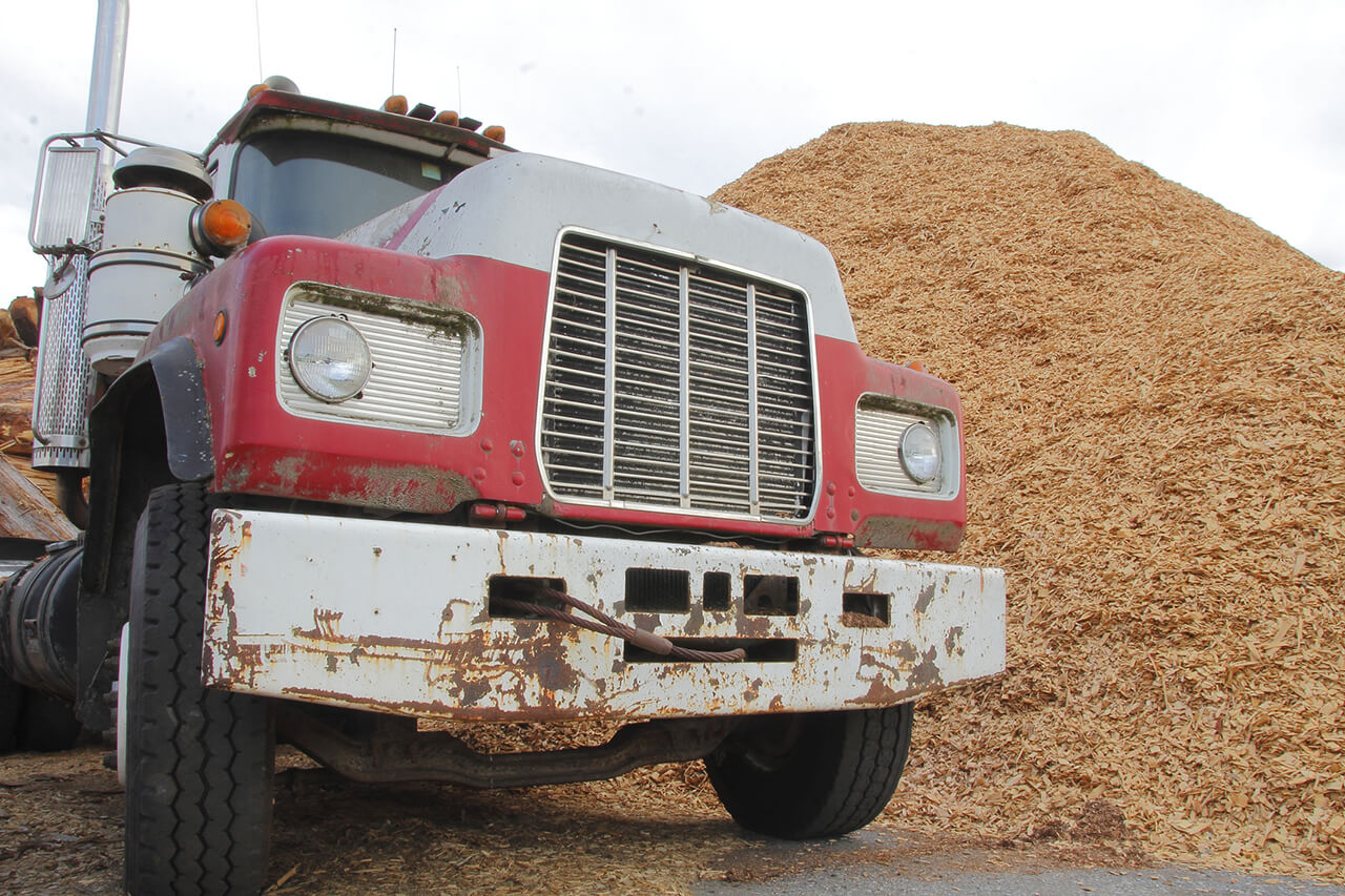 commercial truck delivering big pile of mulch