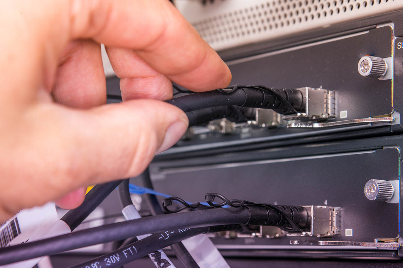 computer network wiring being repaired by technician