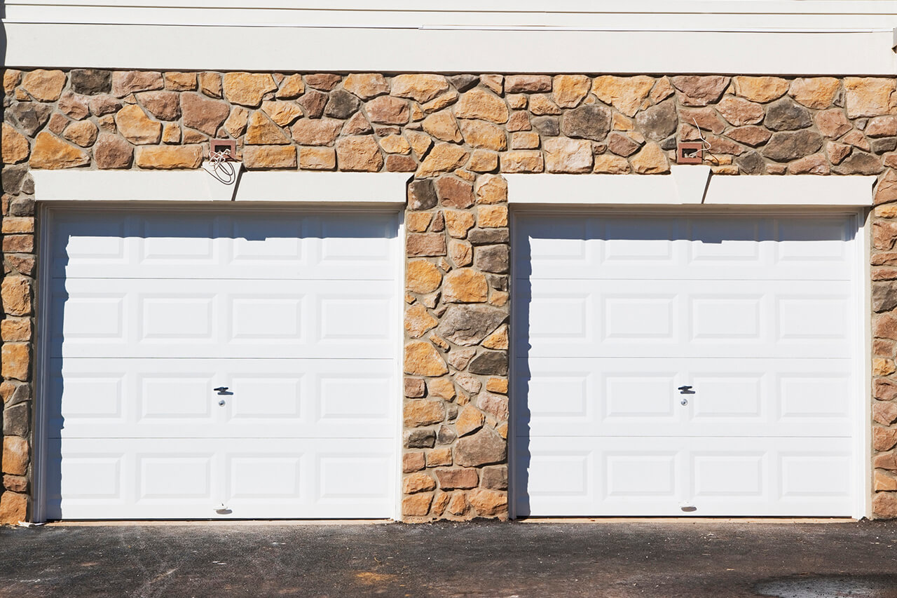 stone home with double garage doors