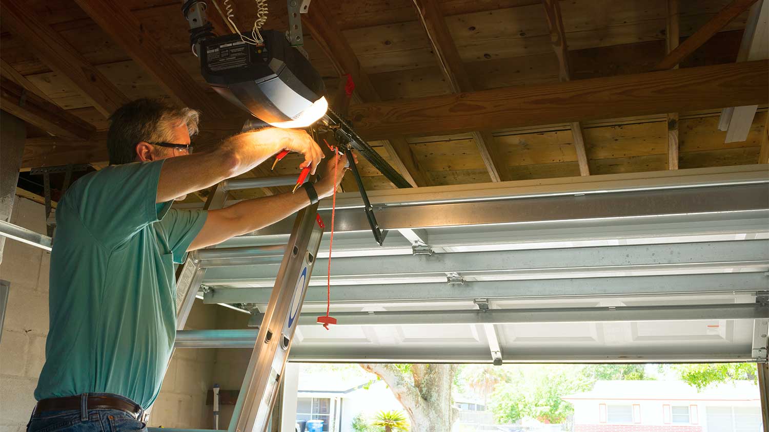 Handyman repairing house garage door