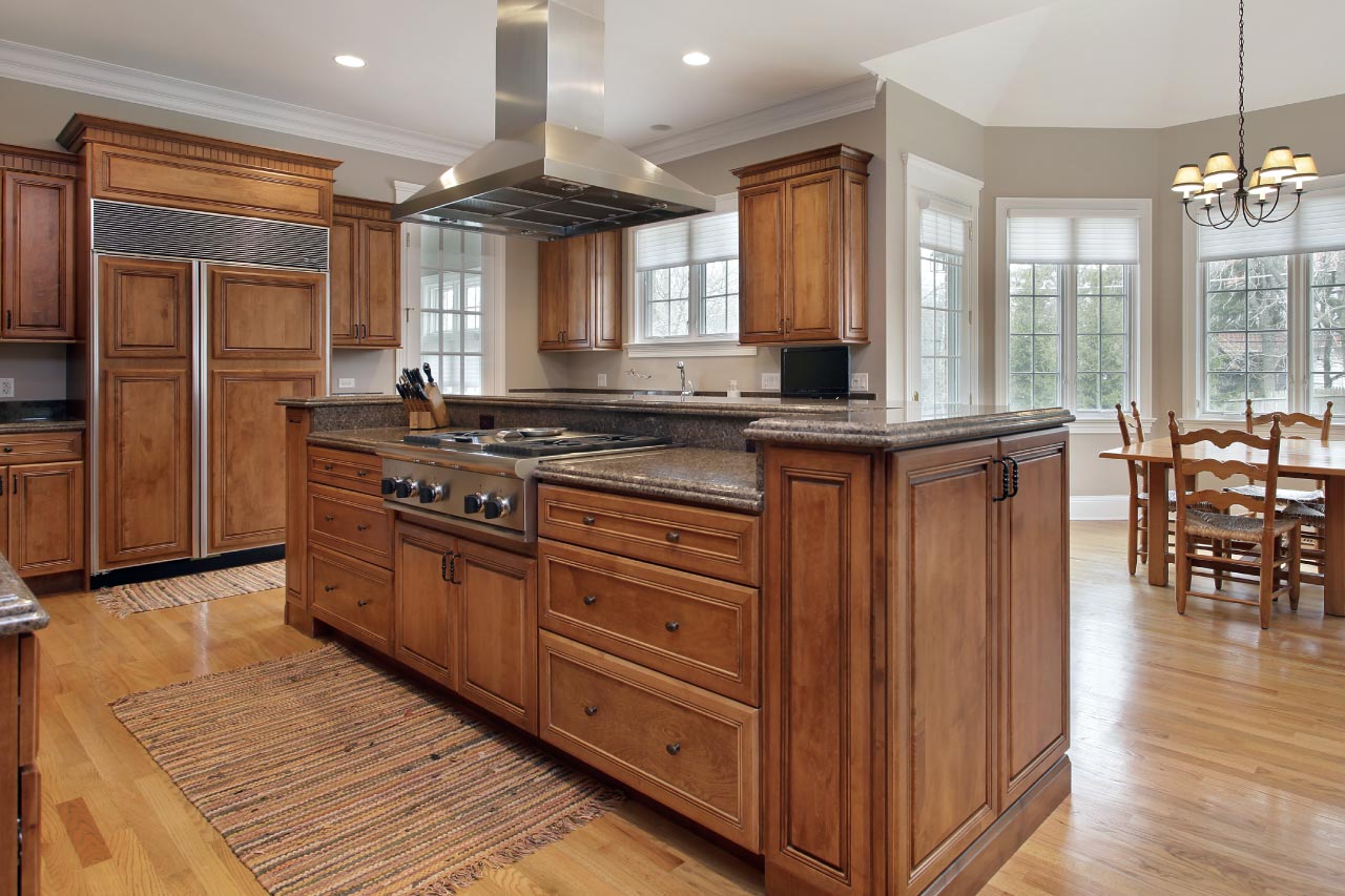 A kitchen with wood cabinets