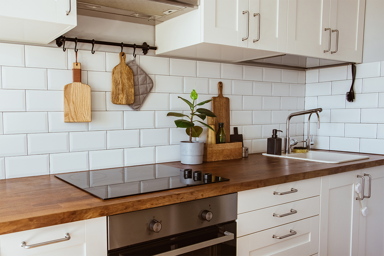 clean white kitchen with wood countertop
