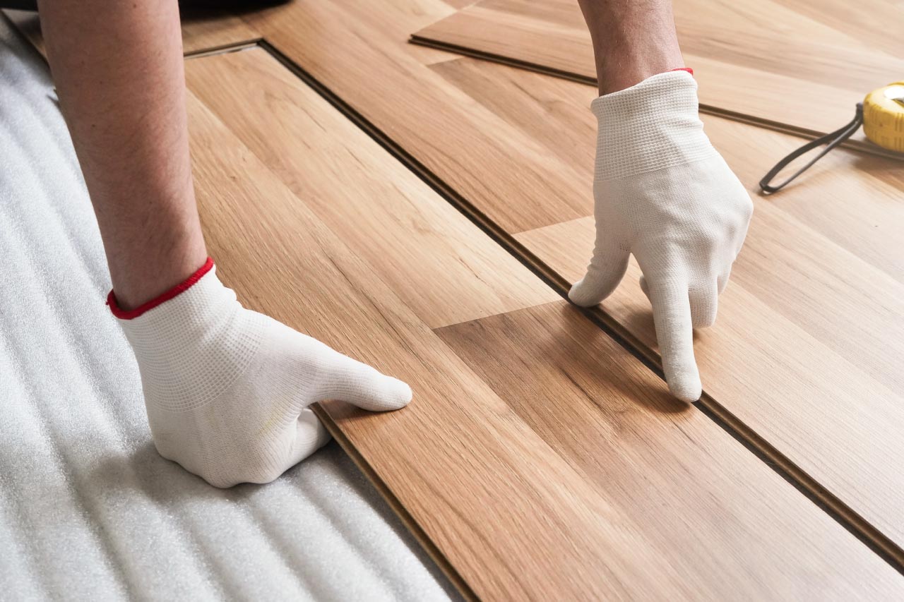 A man installing laminate floor