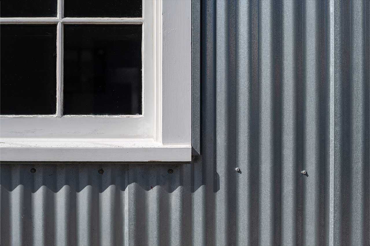 shed with metal siding installed near window