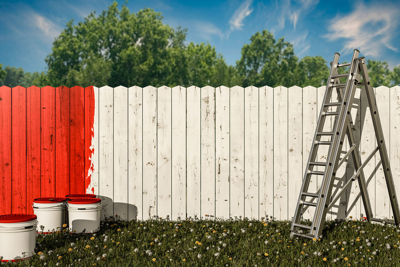 wooden fencing being painted
