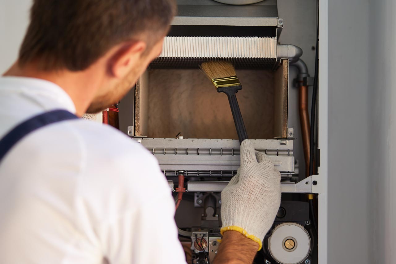 A worker cleaning the radiator heat exchanger